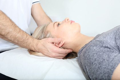 physiotherapist massage patient head